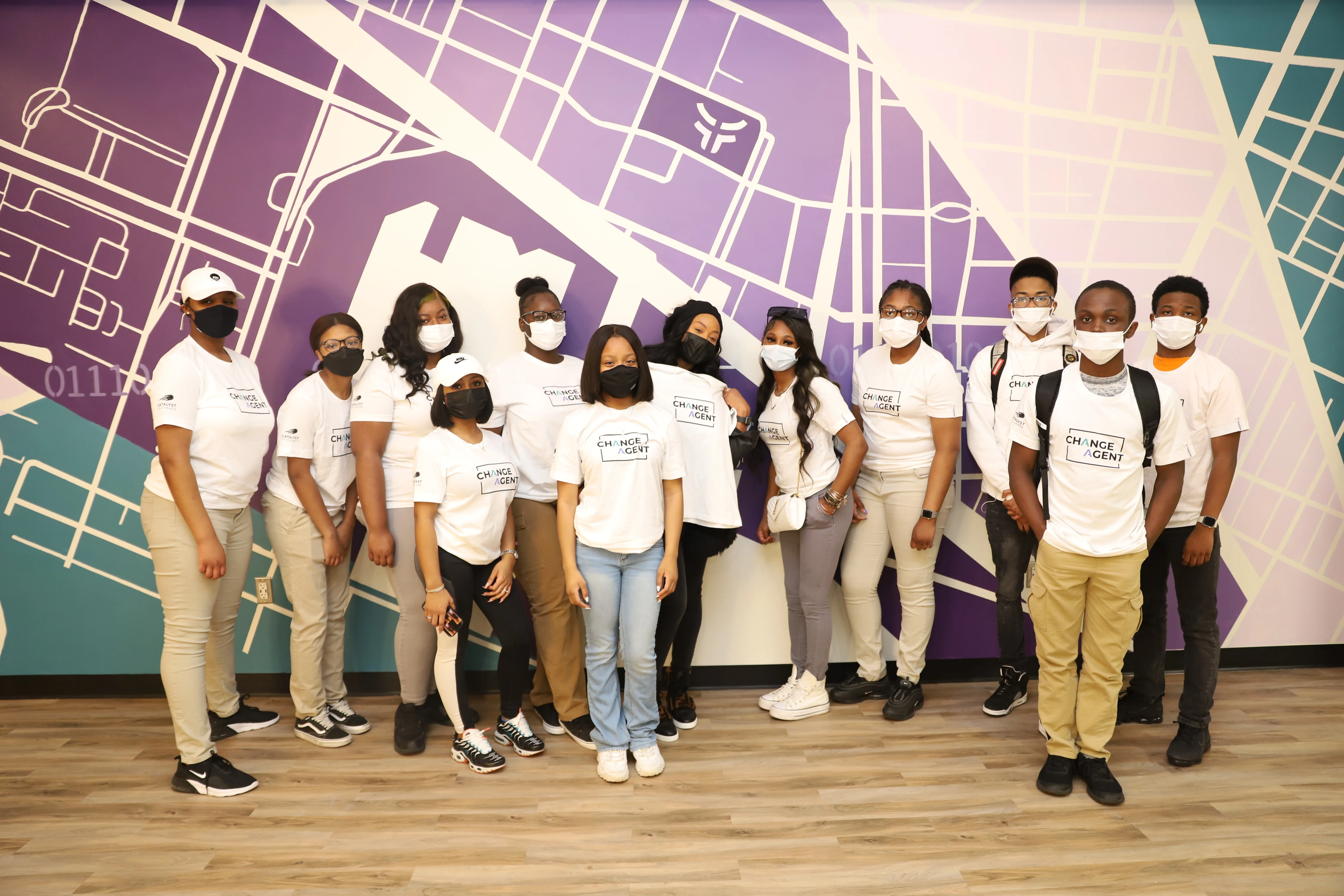 Youth program participants at Fearless office mural